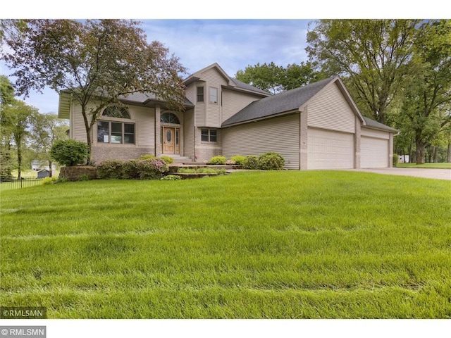 view of front of home with a garage, fence, and a front yard