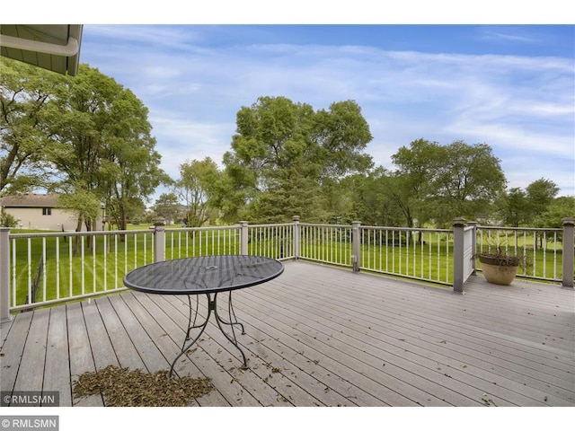 wooden terrace with a lawn