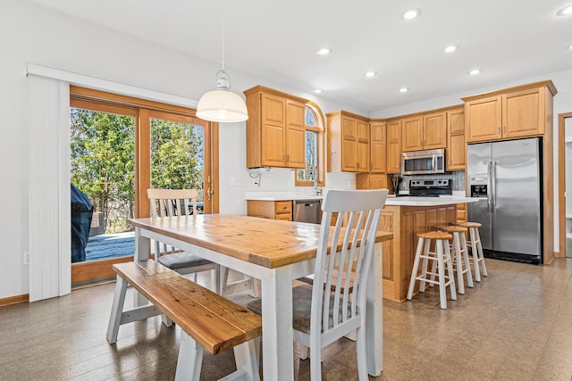 dining room with baseboards and recessed lighting