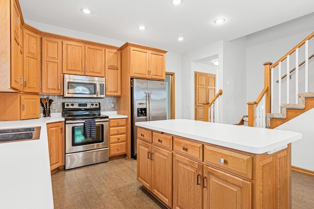 kitchen featuring light countertops, appliances with stainless steel finishes, and recessed lighting