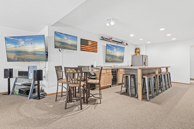 bar featuring light colored carpet, baseboards, beverage cooler, stainless steel fridge, and recessed lighting