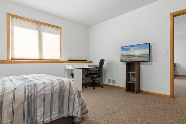carpeted bedroom featuring baseboards and visible vents