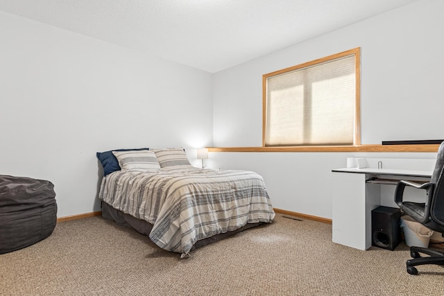 bedroom featuring carpet floors and baseboards