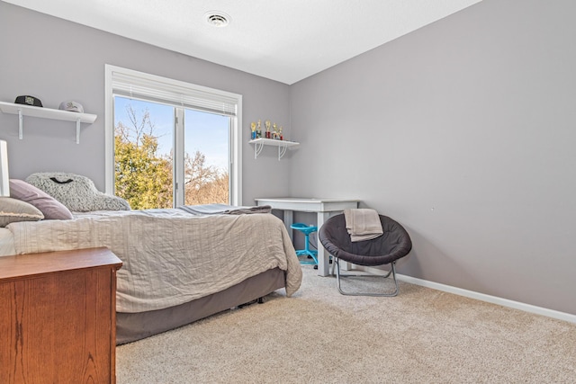 carpeted bedroom with baseboards and visible vents