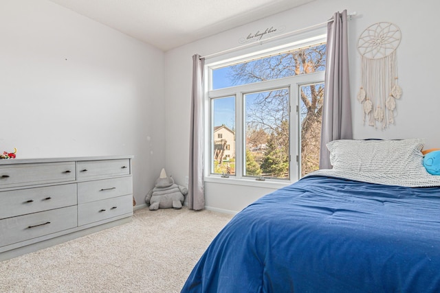bedroom with carpet flooring, baseboards, and multiple windows