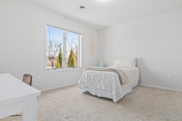 carpeted bedroom featuring baseboards and visible vents