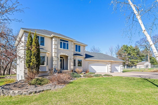 view of front of house featuring a garage, a front lawn, fence, stucco siding, and driveway