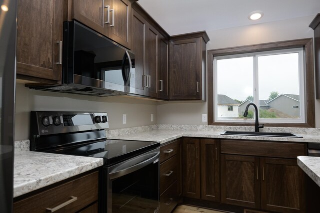 LOT4 Wilderness Ridge Rd SE, Alexandria Twp, MN 56308 - kitchen with dark brown cabinets, stainless steel electric range, black microwave, a sink, and light countertops
