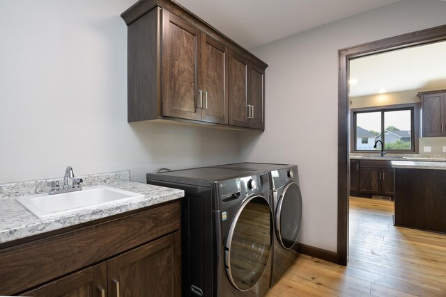 LOT4 Wilderness Ridge Rd SE, Alexandria Twp, MN 56308 - laundry area with a sink, light wood finished floors, cabinet space, and washing machine and clothes dryer