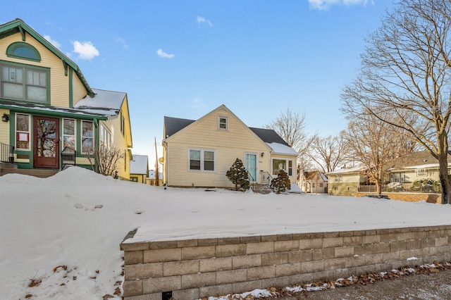 view of snow covered back of property
