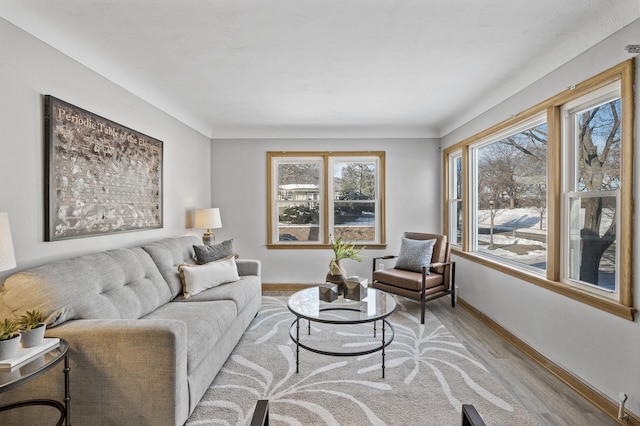 living room featuring baseboards and light wood-style flooring