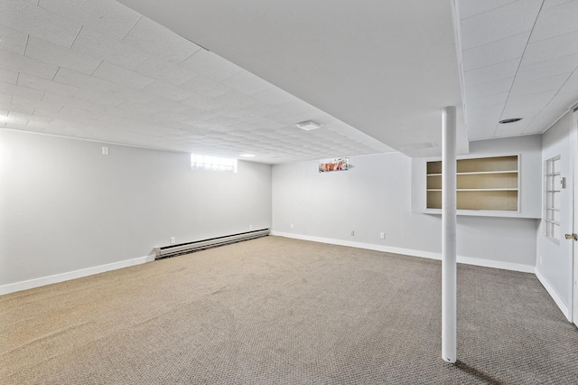 below grade area featuring carpet, baseboards, and baseboard heating