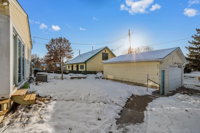 exterior space featuring a detached garage, central AC, and an outdoor structure