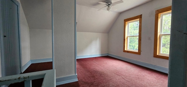 additional living space featuring baseboards, a ceiling fan, carpet, and lofted ceiling