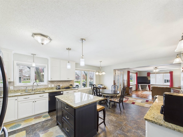 kitchen featuring decorative backsplash, fridge, a sink, white cabinets, and dishwashing machine