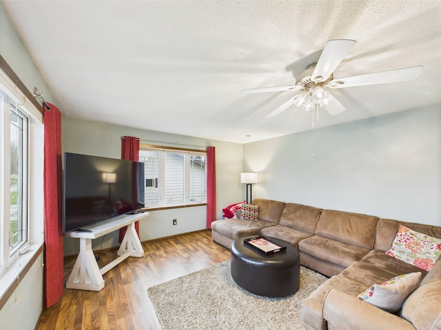 living area featuring ceiling fan and wood finished floors