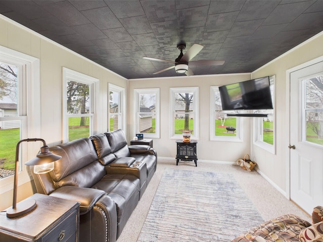 sunroom with carpet flooring, crown molding, and baseboards