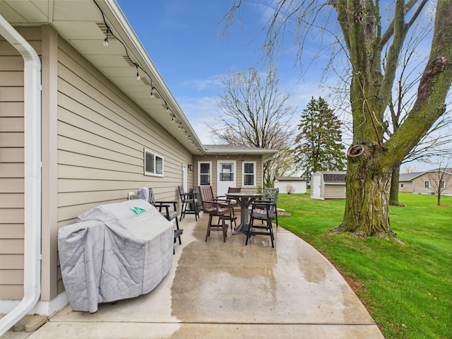 view of patio featuring an outbuilding and outdoor dining space