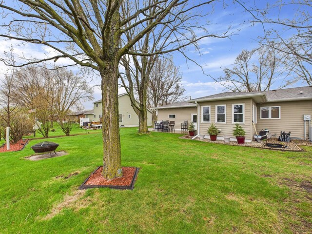 view of yard featuring an outdoor fire pit and a patio area