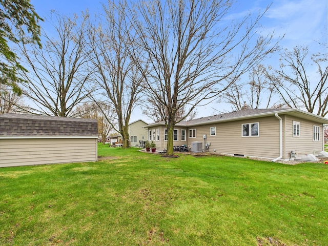 view of yard featuring central AC unit and an outdoor structure
