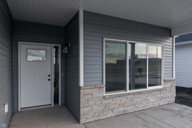 view of exterior entry featuring stone siding