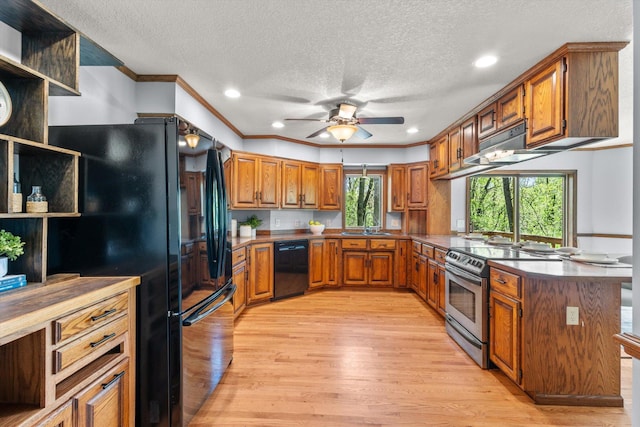 kitchen with black appliances, brown cabinetry, light wood-style floors, ceiling fan, and a textured ceiling