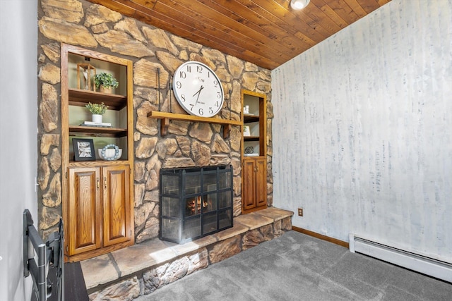 unfurnished living room featuring a baseboard heating unit, wood ceiling, a fireplace, carpet floors, and baseboards