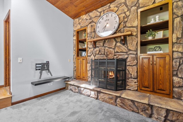 carpeted living room with wooden ceiling, a fireplace, lofted ceiling, baseboards, and built in features