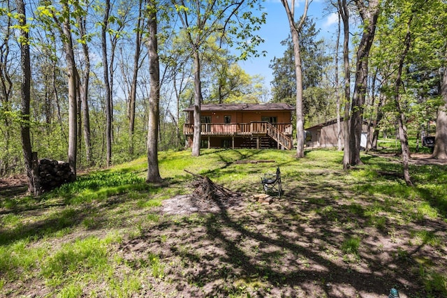 view of yard with a deck and stairs