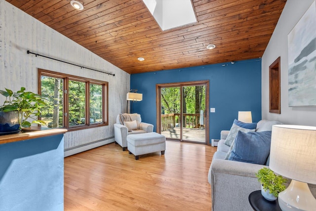 living area with baseboard heating, wood ceiling, vaulted ceiling, a skylight, and wood finished floors