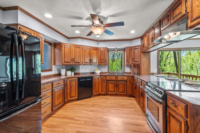 kitchen with black appliances, under cabinet range hood, brown cabinets, a textured ceiling, and dark countertops