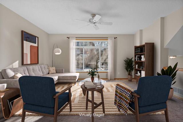 living room with carpet flooring, ceiling fan, and baseboards