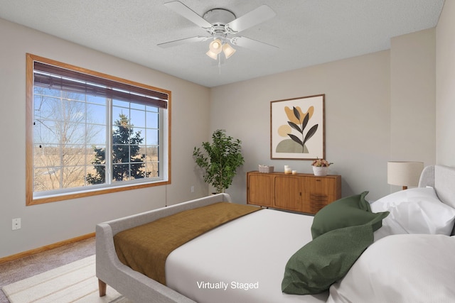 bedroom featuring carpet, baseboards, and a ceiling fan