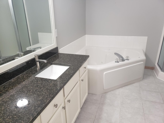 full bath with vanity, tile patterned floors, and a jetted tub