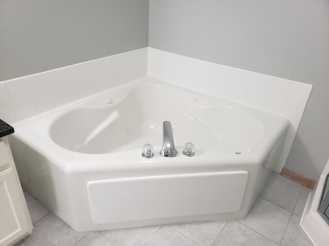 full bath with a jetted tub and tile patterned floors