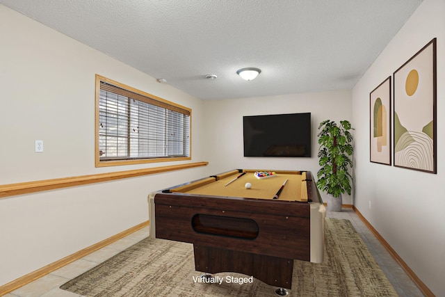 playroom with billiards, a textured ceiling, baseboards, and tile patterned flooring