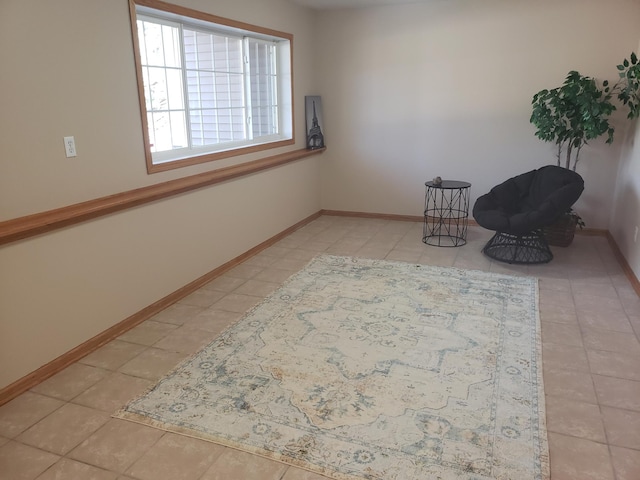 unfurnished room featuring tile patterned flooring and baseboards