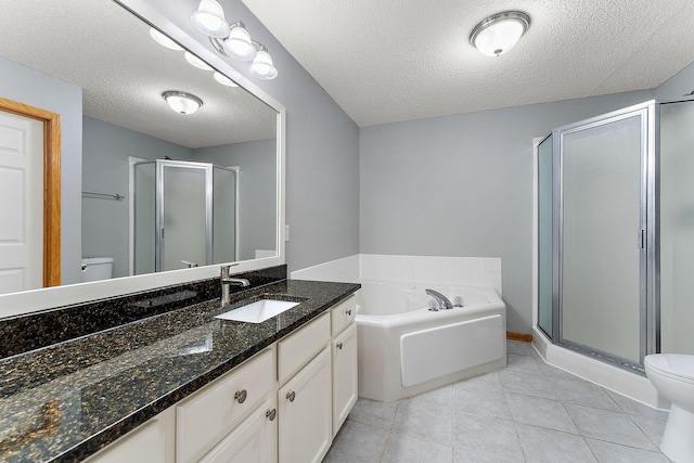 full bathroom featuring toilet, a shower stall, vanity, a textured ceiling, and a bath
