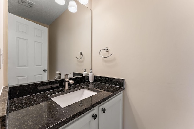 bathroom featuring vanity and a textured ceiling