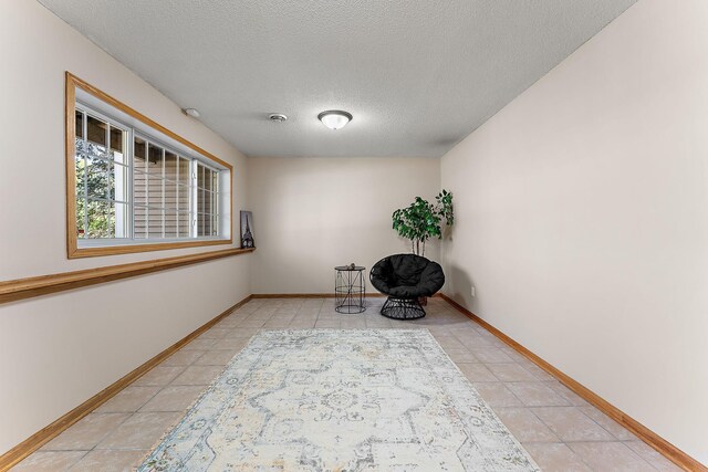 886 Trenton Ln N, Plymouth, MN 55441 - unfurnished room with light tile patterned floors, a textured ceiling, and baseboards
