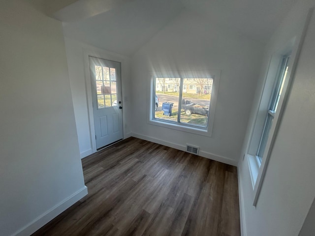 507 Peck St, Fergus Falls, MN 56537 - unfurnished dining area featuring dark wood-style floors, baseboards, and vaulted ceiling
