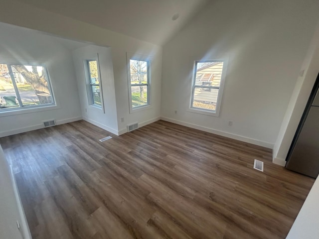 507 Peck St, Fergus Falls, MN 56537 - unfurnished living room with lofted ceiling, dark wood-style floors, and baseboards