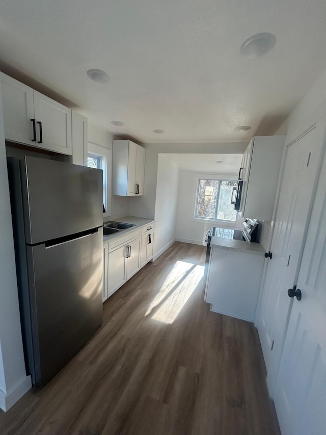 507 Peck St, Fergus Falls, MN 56537 - kitchen featuring a wealth of natural light, stainless steel appliances, white cabinets, and dark wood finished floors