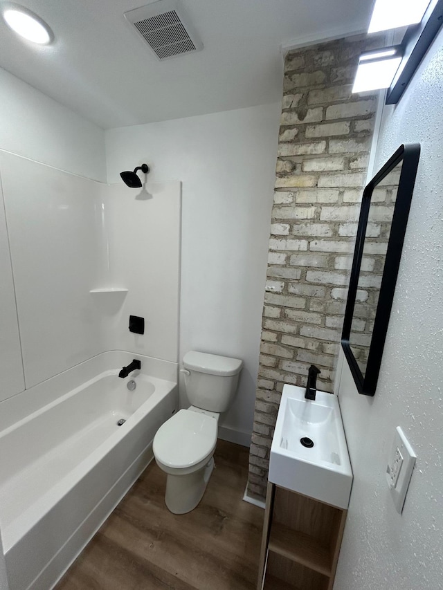 507 Peck St, Fergus Falls, MN 56537 - full bathroom with toilet, wood finished floors, shower / washtub combination, visible vents, and vanity