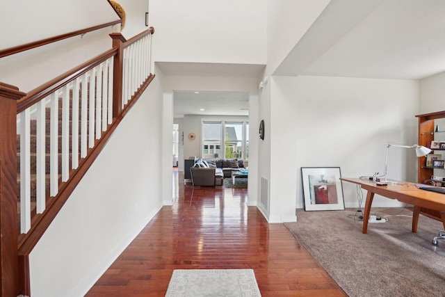 foyer entrance featuring wood finished floors and baseboards