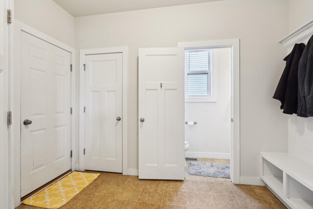 mudroom featuring baseboards and light tile patterned flooring