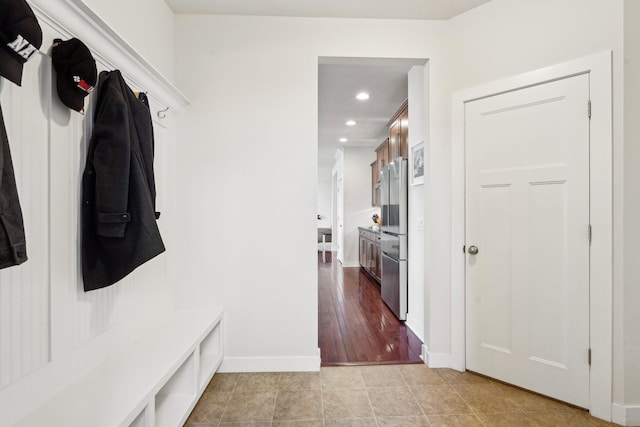 mudroom with recessed lighting, baseboards, and light tile patterned flooring