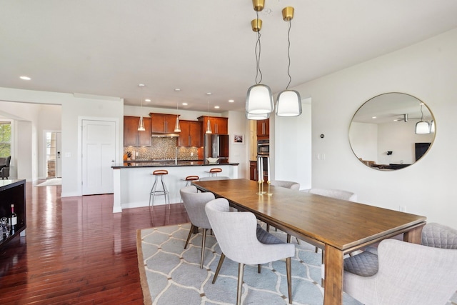 dining area featuring dark wood finished floors and recessed lighting