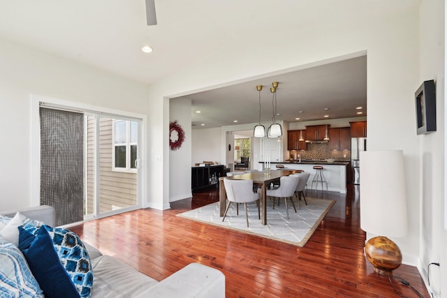 living room with hardwood / wood-style flooring, vaulted ceiling, recessed lighting, and a ceiling fan