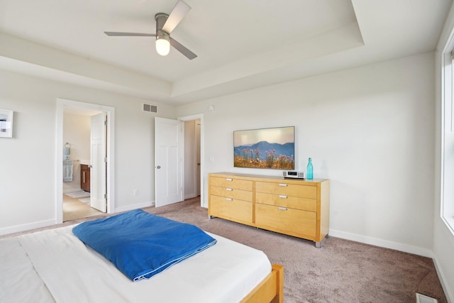 bedroom with light colored carpet, baseboards, and connected bathroom